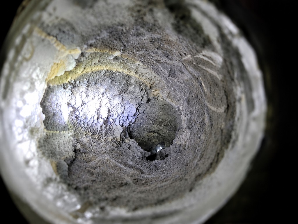 Clogged dryer vent caked with lint after 8 years without cleaning